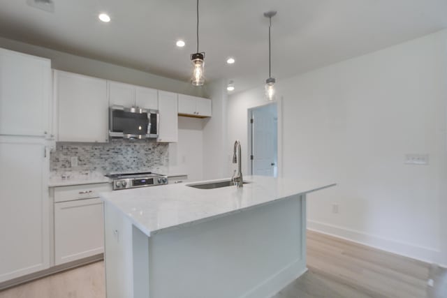 2135 Clayton St, Charleston, SC 29414 - kitchen with appliances with stainless steel finishes, a sink, light wood-type flooring, backsplash, and recessed lighting