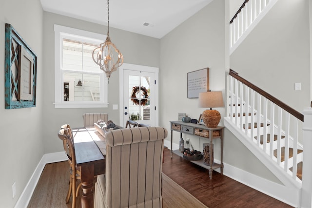 dining area featuring an inviting chandelier and dark hardwood / wood-style flooring