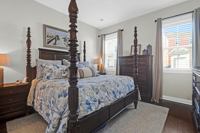 bedroom with dark wood-type flooring