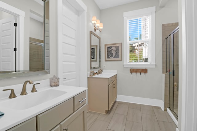 bathroom with vanity, a shower with shower door, and tile patterned floors