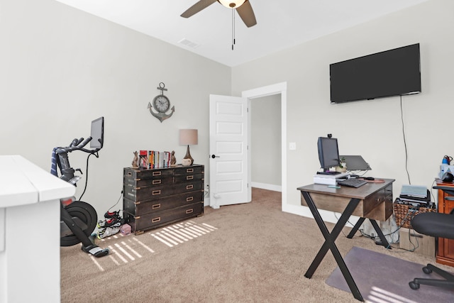 carpeted office featuring ceiling fan