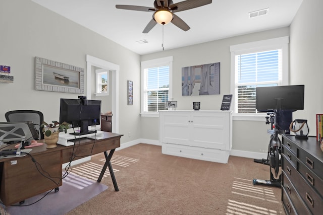 carpeted office space with ceiling fan