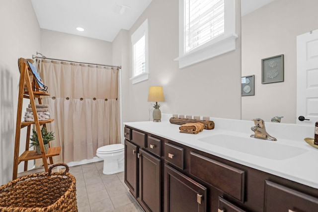 bathroom with vanity, a shower with shower curtain, toilet, and tile patterned floors