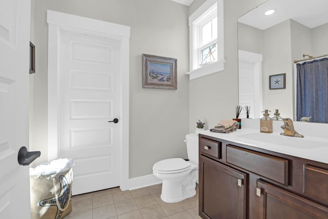 bathroom featuring vanity, toilet, and tile patterned flooring