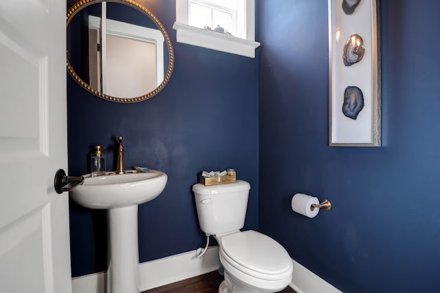 bathroom with toilet and hardwood / wood-style floors