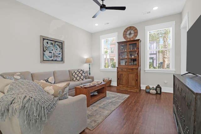 living room featuring dark hardwood / wood-style flooring, ceiling fan, and plenty of natural light