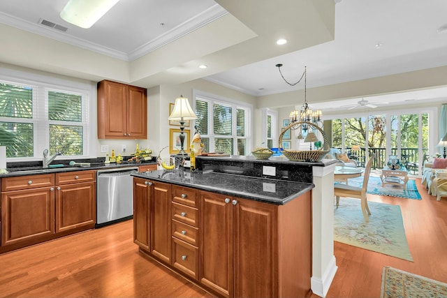 kitchen with sink, crown molding, dishwasher, an island with sink, and dark stone counters