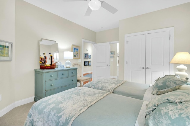 carpeted bedroom featuring a closet and ceiling fan