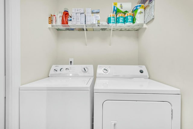 clothes washing area featuring separate washer and dryer