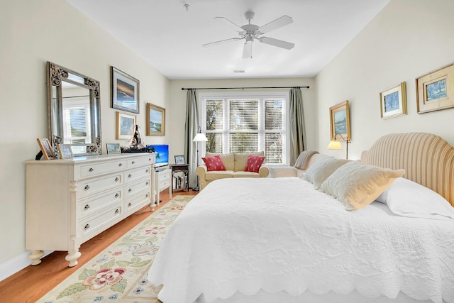 bedroom with ceiling fan and light hardwood / wood-style floors