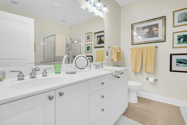 bathroom with vanity, tile patterned floors, toilet, and walk in shower