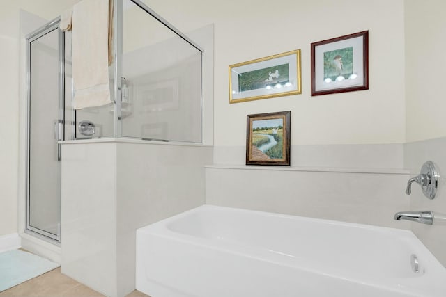 bathroom with tile patterned flooring and independent shower and bath