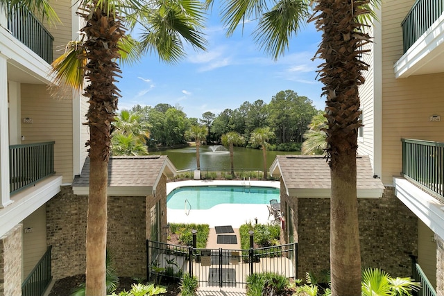 view of swimming pool featuring a water view