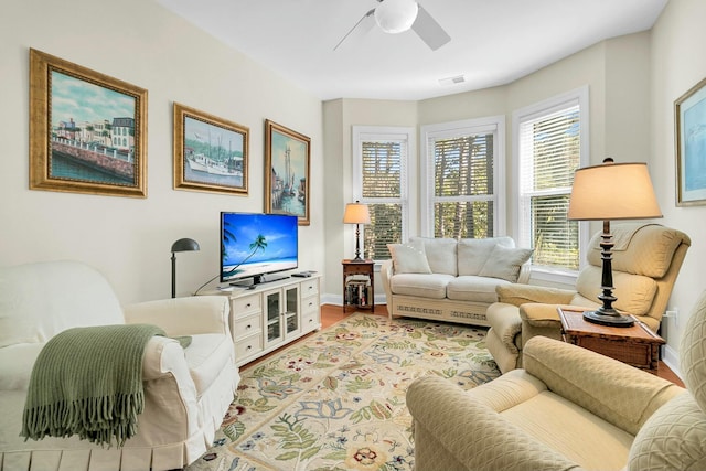 living room with ceiling fan and light wood-type flooring