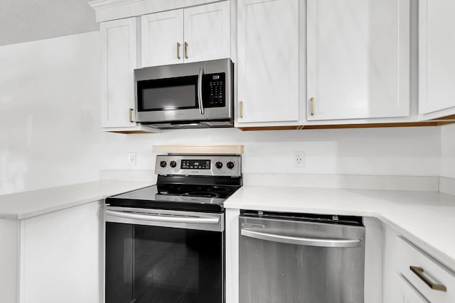 kitchen with white cabinets and appliances with stainless steel finishes