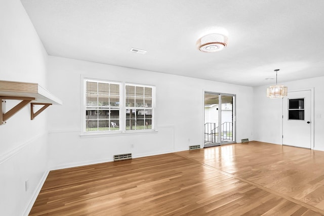 interior space with hardwood / wood-style flooring and an inviting chandelier