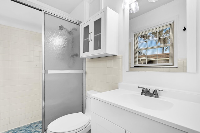 bathroom with vanity, toilet, and an enclosed shower