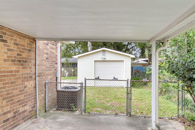 view of patio with an outbuilding, a garage, and central air condition unit