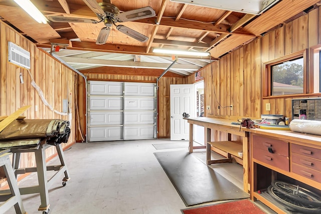 garage with a workshop area and wood walls