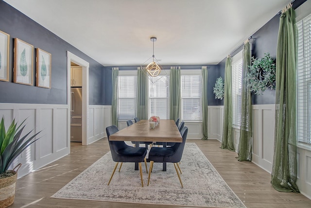 dining space with plenty of natural light and light wood-type flooring