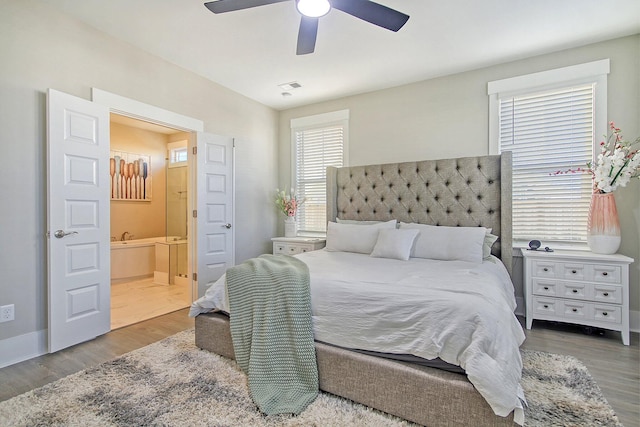 bedroom with connected bathroom, wood-type flooring, and ceiling fan