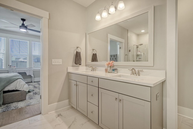 bathroom with ceiling fan, vanity, and a shower with door