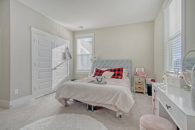 bedroom featuring light colored carpet