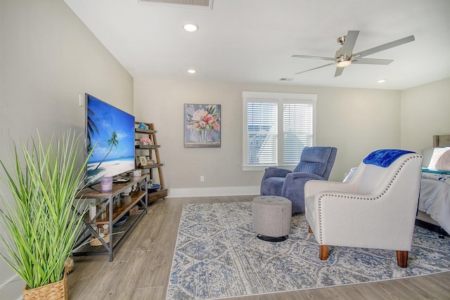 living area featuring ceiling fan and light hardwood / wood-style floors