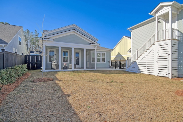 rear view of house featuring a yard and a patio area