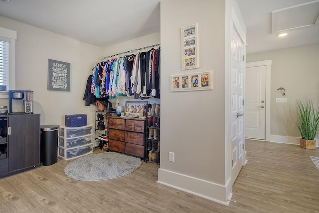 spacious closet with light hardwood / wood-style flooring