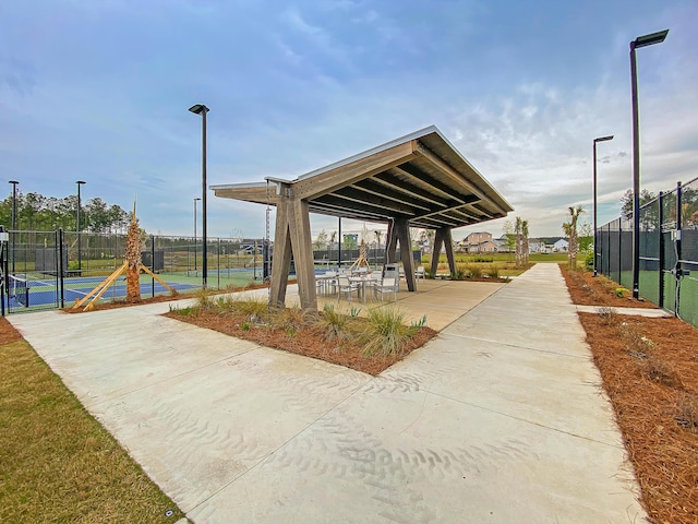 surrounding community featuring tennis court