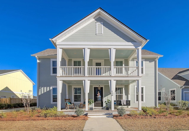 view of front facade with a balcony and covered porch