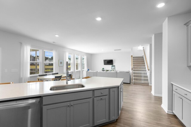 211 Squire Pope Rd, Summerville, SC 29486 - kitchen featuring stainless steel dishwasher, a sink, gray cabinetry, light countertops, and open floor plan