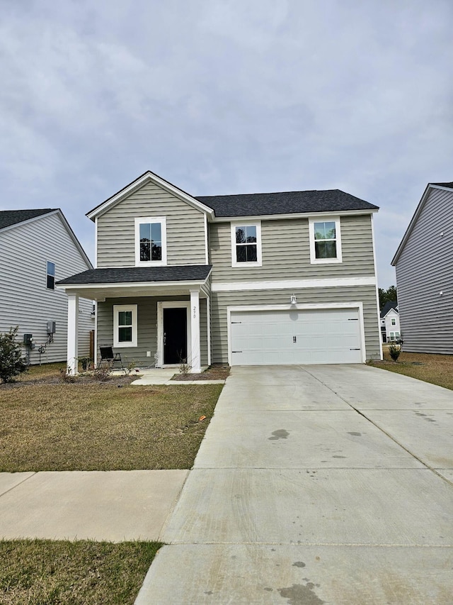 traditional-style home featuring concrete driveway, covered porch, and a garage