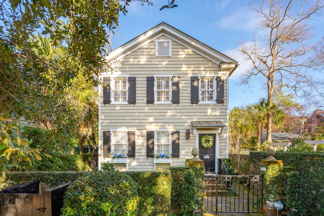 view of front of home with a fenced front yard and a gate