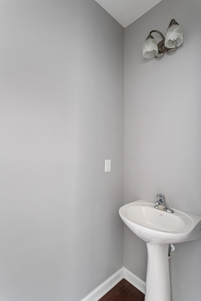 bathroom with sink and wood-type flooring