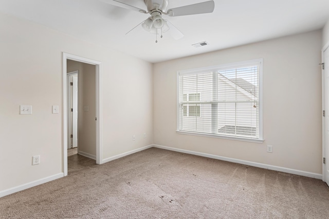 spare room featuring carpet floors and ceiling fan