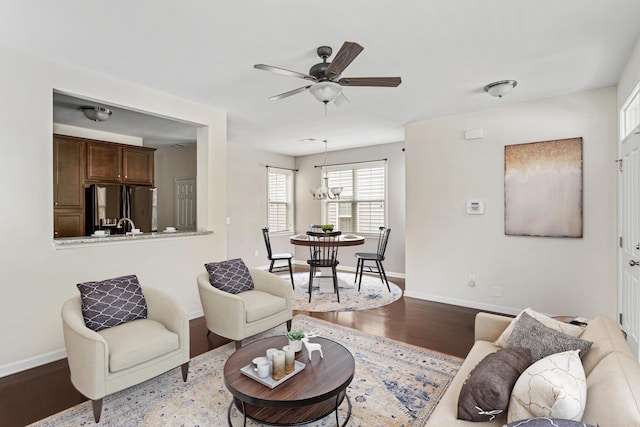 living room featuring hardwood / wood-style floors and ceiling fan