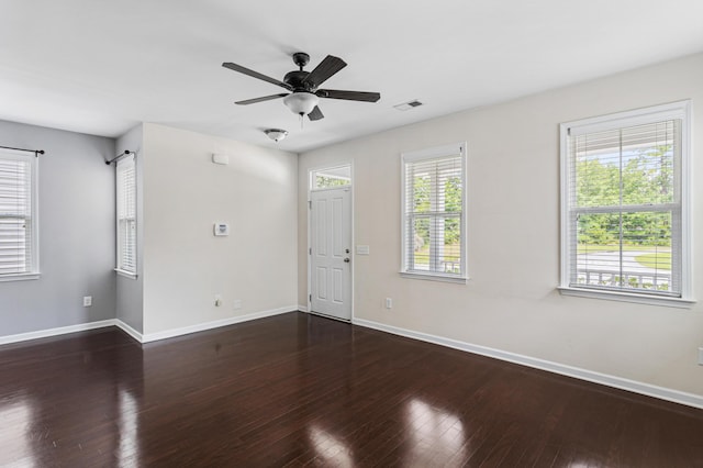 unfurnished room with dark wood-type flooring and ceiling fan