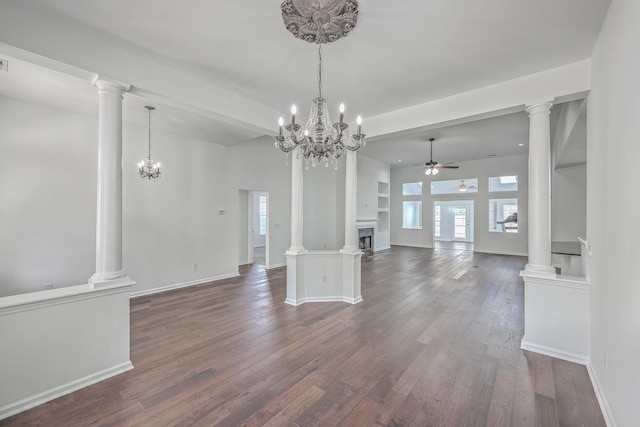 unfurnished living room featuring ornate columns, dark wood-type flooring, and ceiling fan