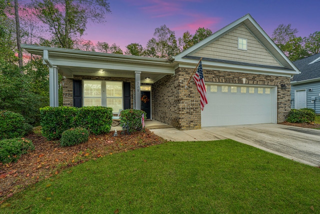 view of front of home featuring a lawn and a garage