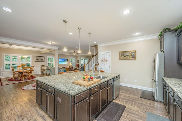 220 Brutus Ln, Summerville, SC 29485 - kitchen featuring a sink, appliances with stainless steel finishes, light wood finished floors, crown molding, and dark brown cabinetry