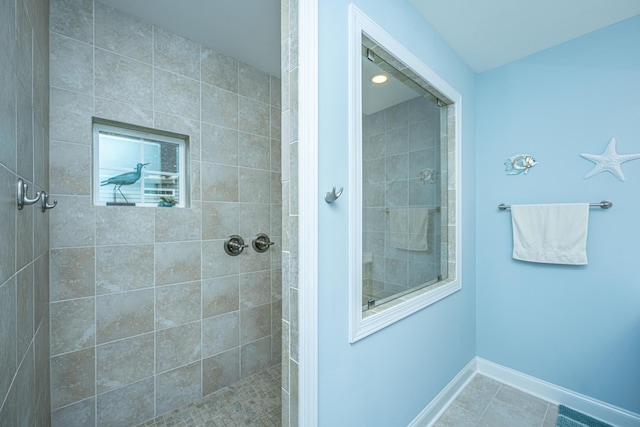 220 Brutus Ln, Summerville, SC 29485 - bathroom with tiled shower, baseboards, and tile patterned floors