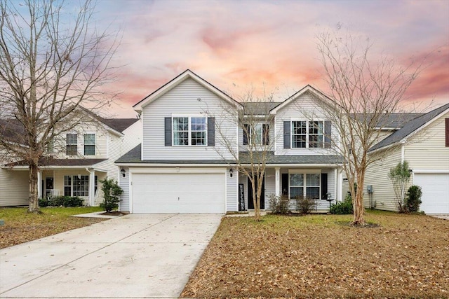 view of front property featuring a lawn and a garage