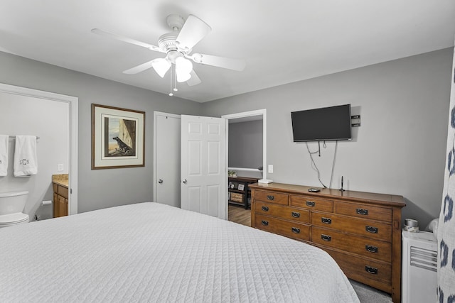 bedroom with ceiling fan and connected bathroom