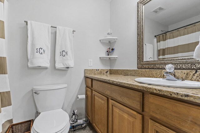 bathroom featuring vanity and toilet