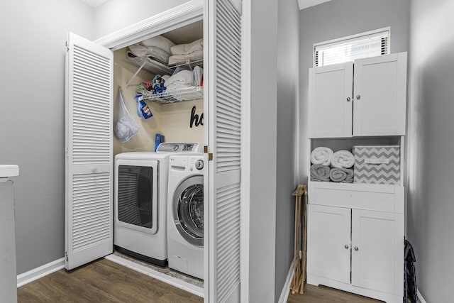 clothes washing area featuring dark hardwood / wood-style flooring and washing machine and dryer