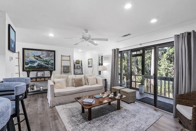 living room featuring hardwood / wood-style floors and ceiling fan