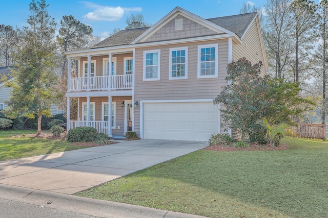 view of front of property featuring a porch, a front yard, concrete driveway, and a shingled roof