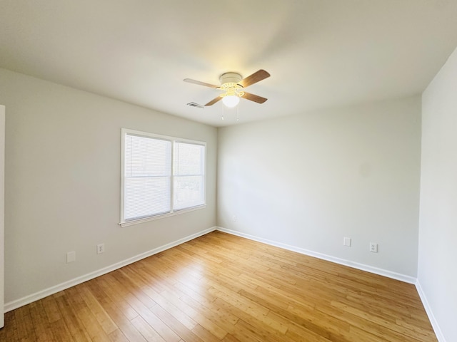 empty room featuring visible vents, baseboards, light wood-style floors, and a ceiling fan